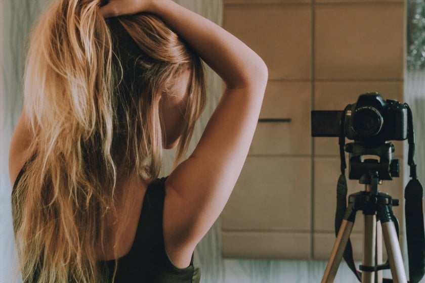 A girl holds her hair in front of the camera | Skylum Blog