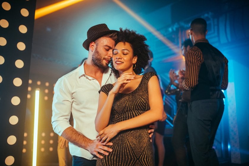 Couple on the dance floor with people in the background | Skylum Blog