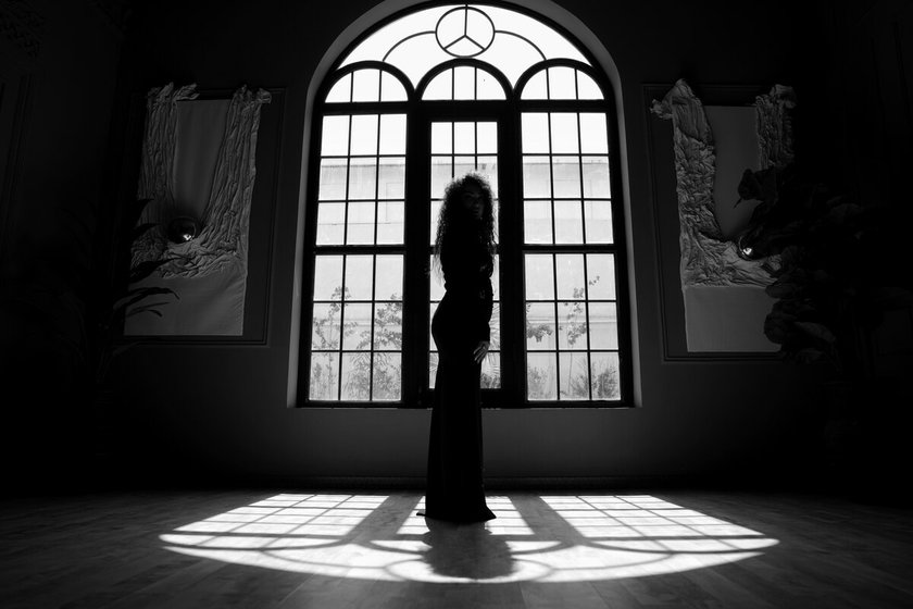 A photo of a girl in the shade near a window | Skylum Blog