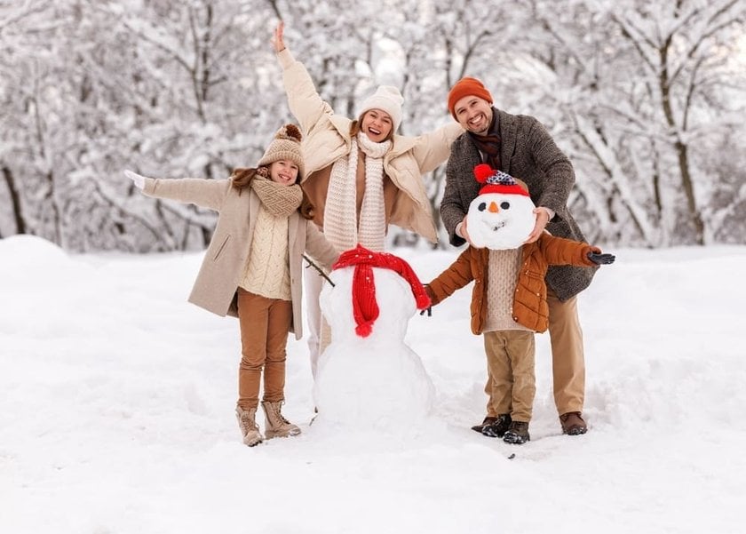 Family Making a Snowman and Having Fun in Winter | Skylum Blog