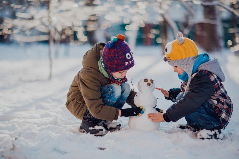 Children Building a Snowman in Winter | Skylum Blog