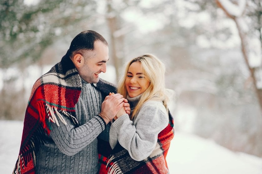 Couple Wrapped in Blankets Holding Hands | Skylum Blog