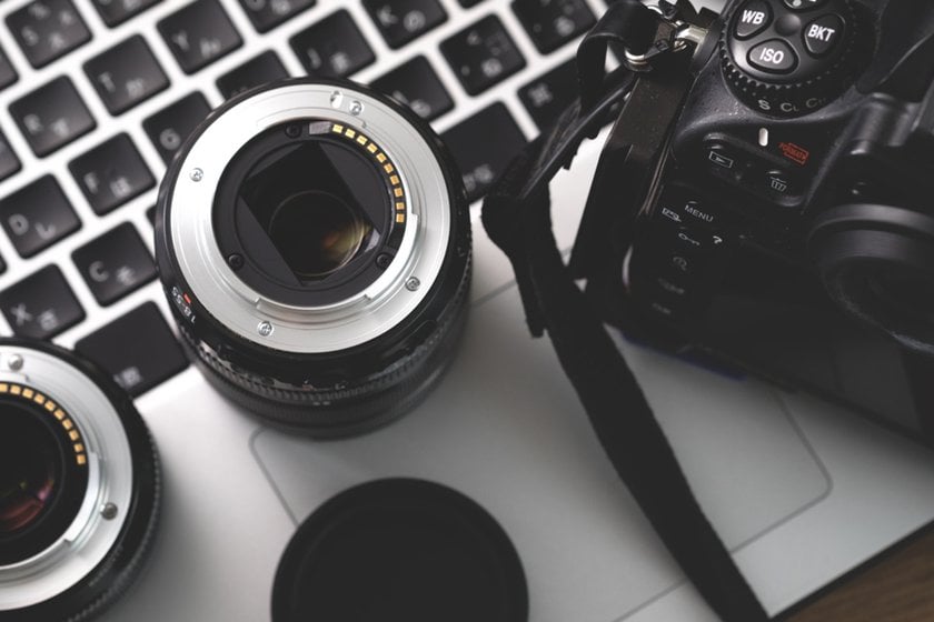 Camera and lenses on a laptop | Aperty Blog