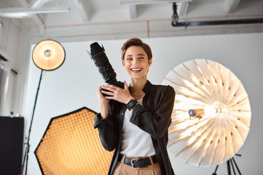 Photographer in a photo studio with a camera in his hands | Aperty Blog