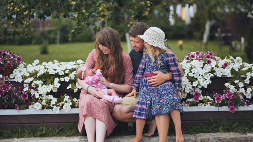 A family with a newborn and a preschooler on the street | Aperty Blog