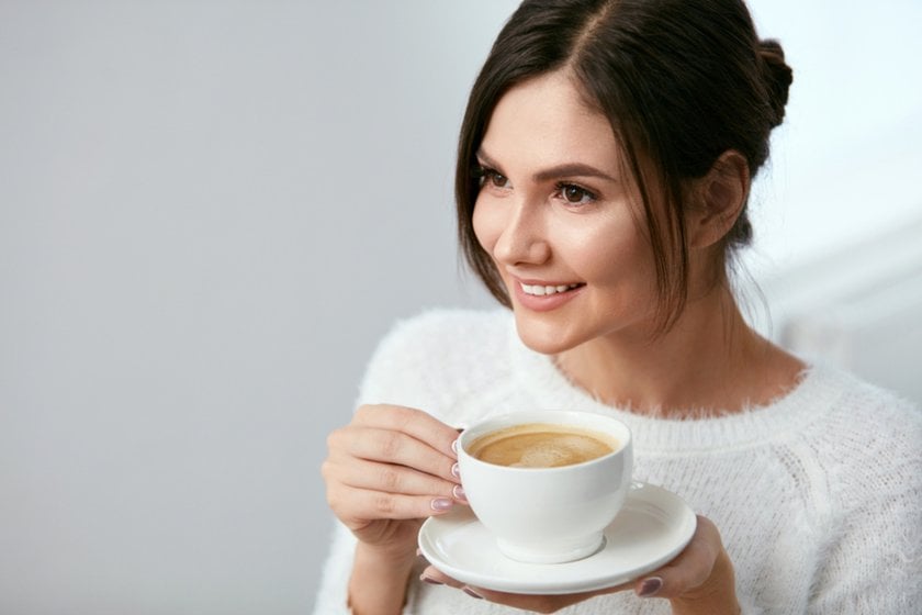 A girl holds a cup of coffee in her hands | Skylum Blog
