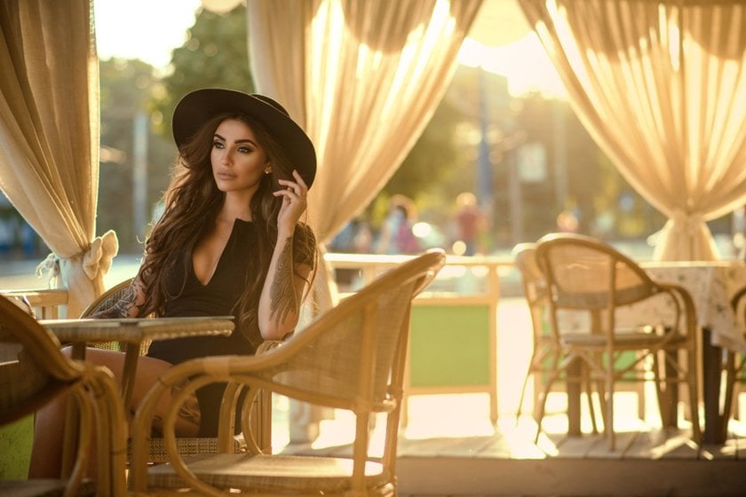Girl in hat holds hand near her | Skylum Blog