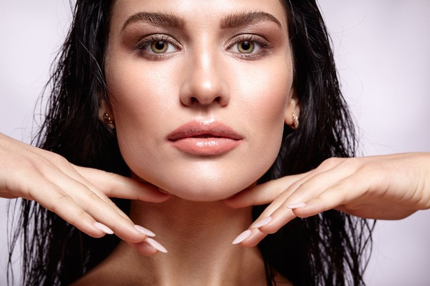 Portrait of a girl holding her hands near her cheekbones | Skylum Blog