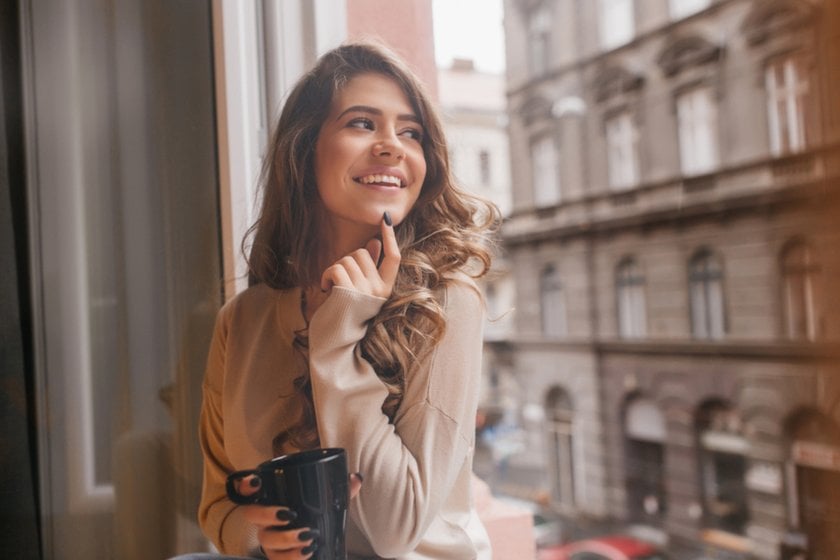 Portrait of a girl with a finger on her chin and a cup in her hand | Skylum Blog