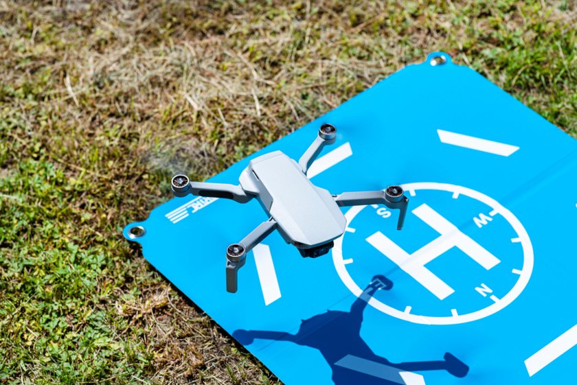 The drone hovered over the blue landing pad | Skylum Blog