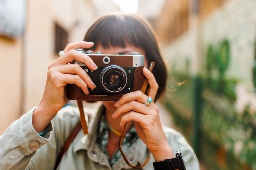 Girl Posing with a Retro Camera for a Photo | Skylum Blog