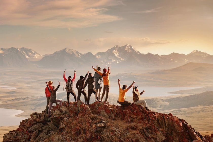 Group of Tourists Celebrating at the Mountain Peak | Skylum Blog