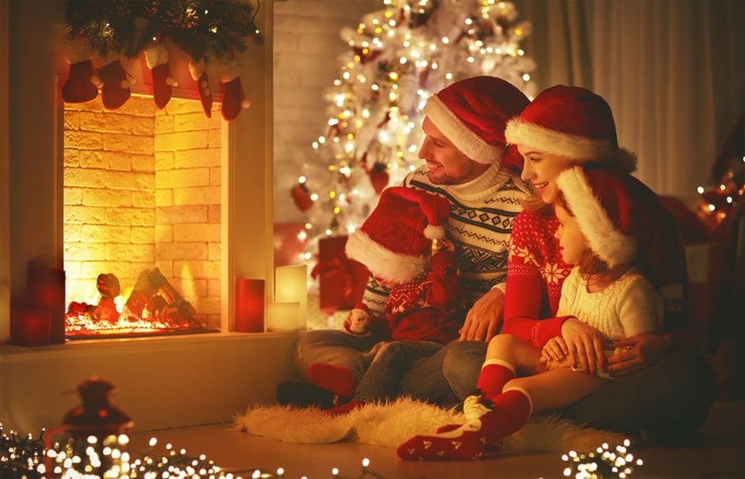 Cozy Photo of a New Year's Family Sitting by the Fireplace | Skylum Blog