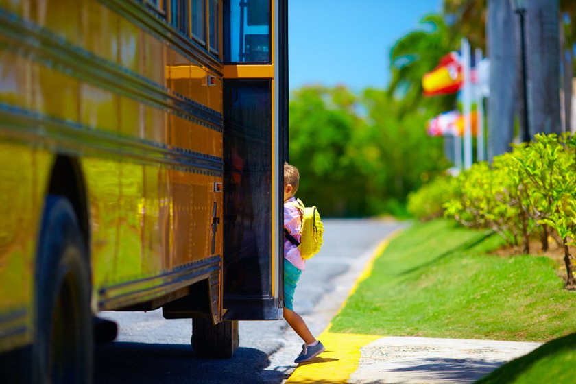 A schoolboy enters a school bus | Skylum Blog