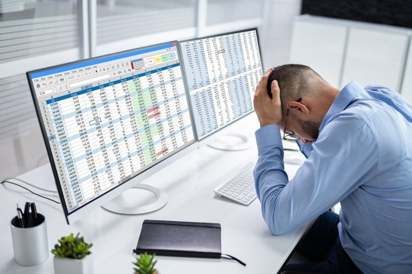 People at computers with spreadsheets on screen | Skylum Blog