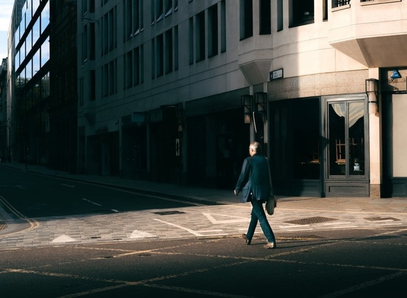 A man moves down the street into the shadows | Skylum Blog