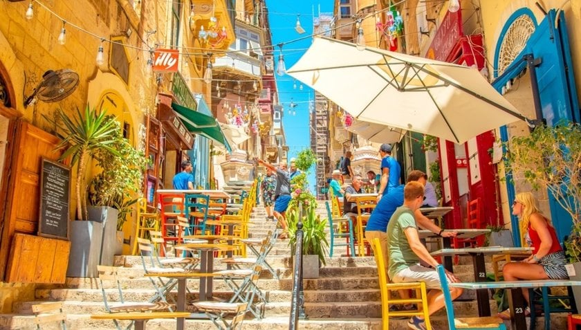 A colorful city street with tables and visitors | Skylum Blog