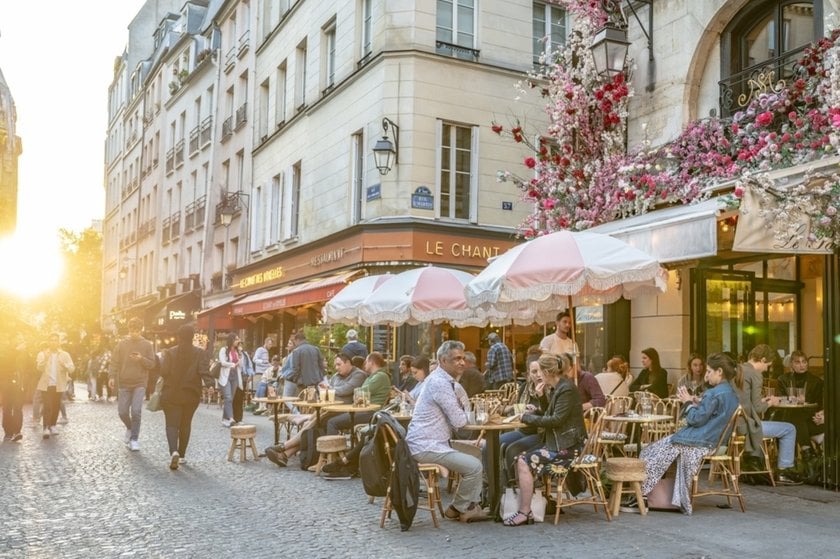 Photo of a street with people sitting on the street | Skylum Blog