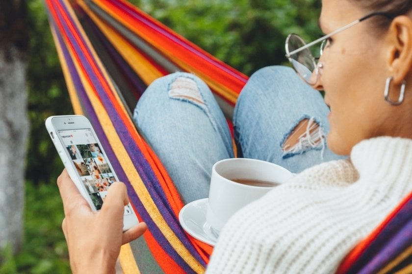 A girl scrolls through her Instagram feed | Skylum Blog