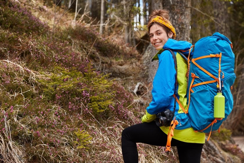 A girl with equipment in the forest | Skylum Blog