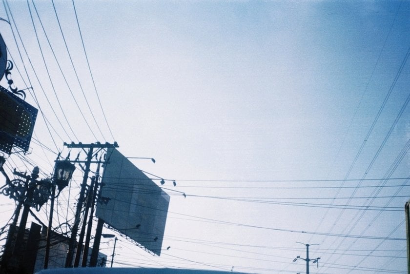 A blurry photo of the sky and a billboard | Skylum Blog