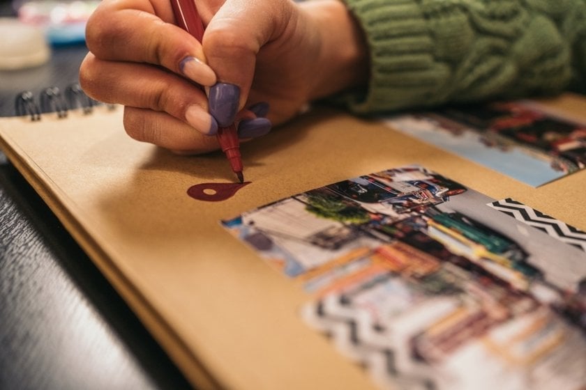 A girl draws in a photo album  | Skylum Blog