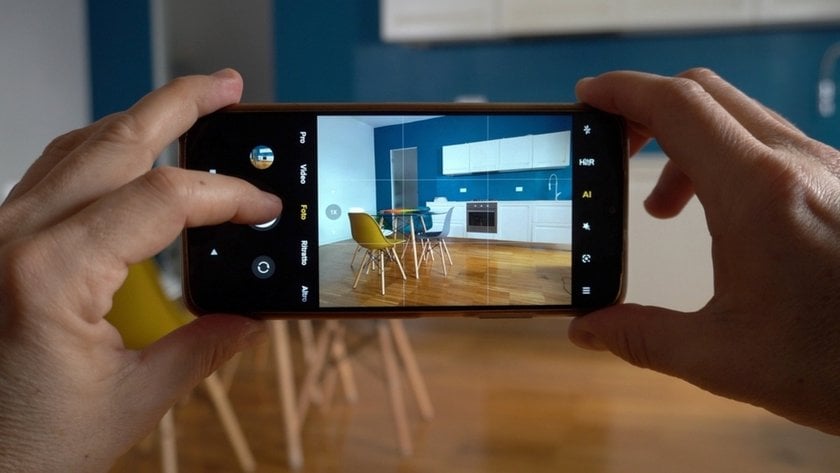 A man takes a photo of his kitchen on his smartphone | Skylum Blog