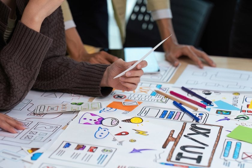 Colleagues look at drawings and ideas | Skylum Blog