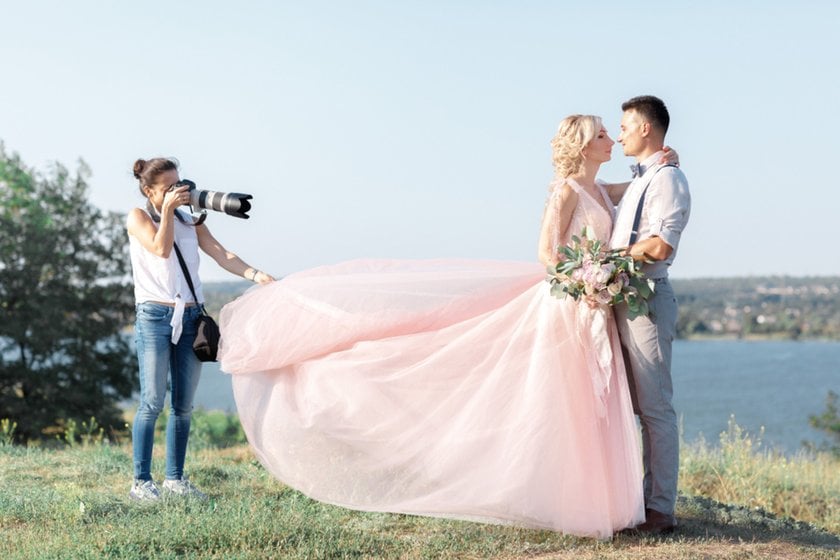 A photographer takes a photo of the newlyweds | Skylum Blog