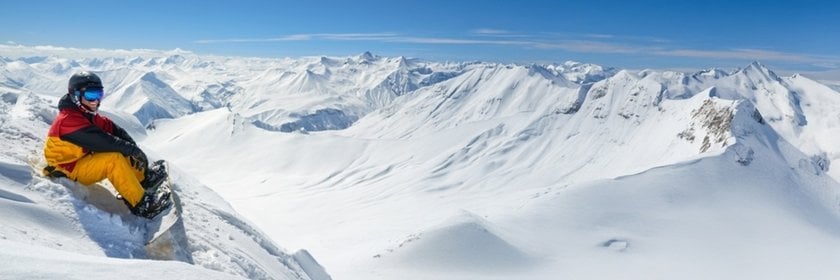 Photo of a snowboarder in the mountains | Skylum Blog