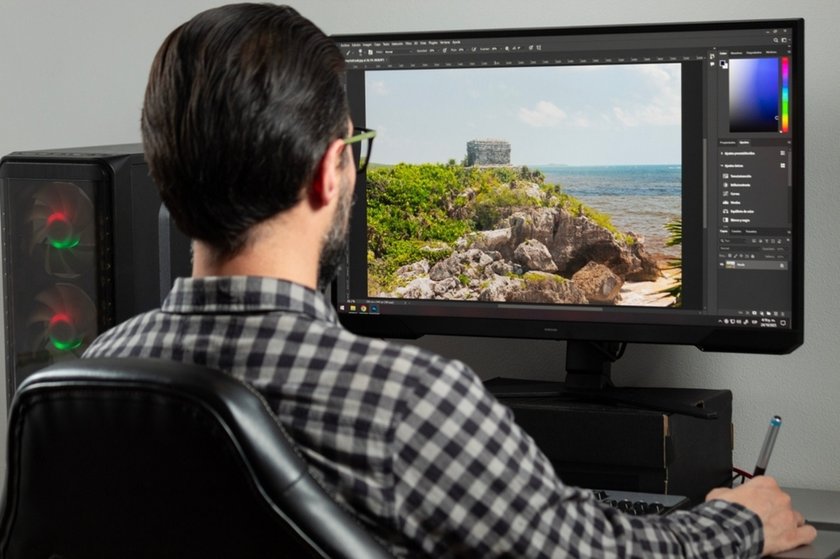 A man edits a photo in Photoshop | Skylum Blog