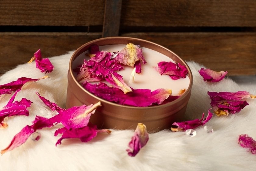 A lit candle with rose petals | Skylum Blog