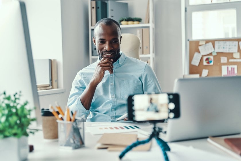 Man smiling for a hands-free selfie using a phone timer | Skylum How-to