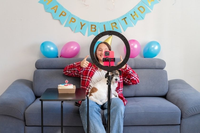 Woman positioning phone on tripod for a hands-free picture | Skylum How-to