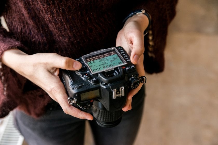 A photographer adjusts his camera | Skylum Blog