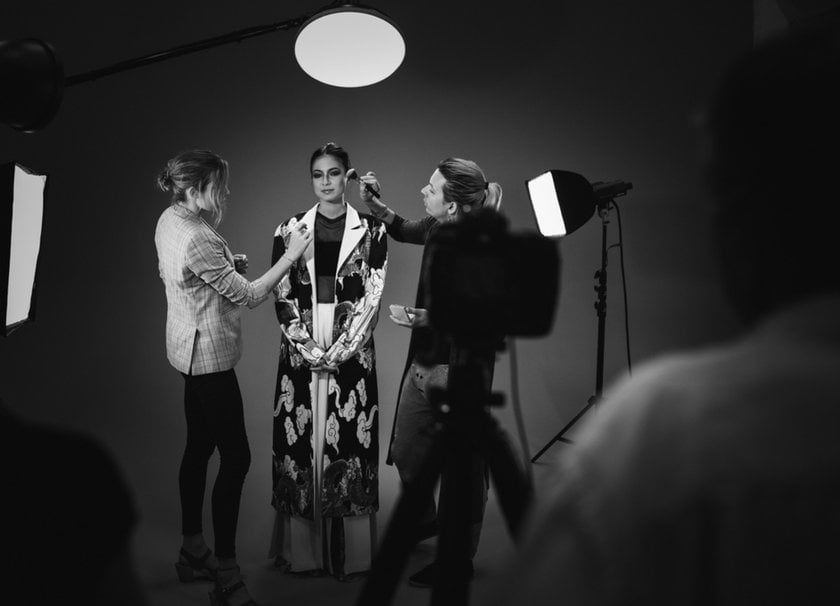 Stylists touch up a model's makeup during a photo shoot | Skylum How-to