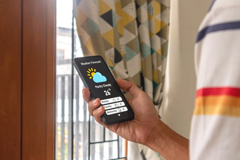 A man looks at the weather forecast | Skylum Blog
