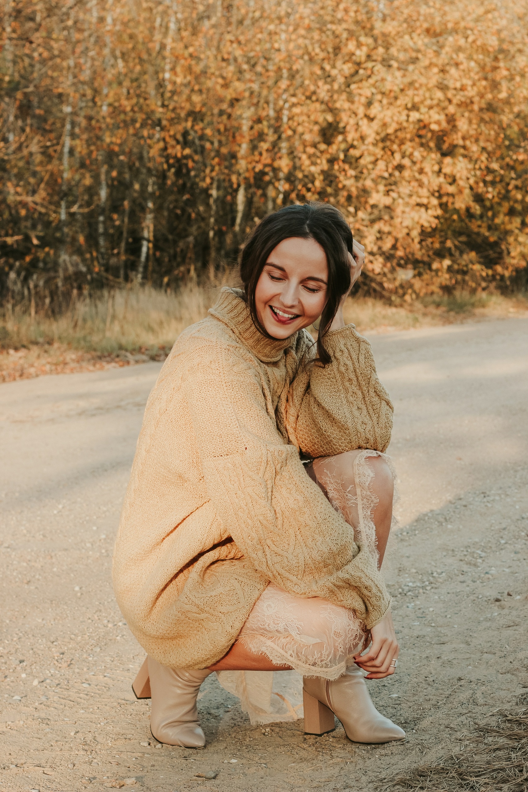 Premium Photo | Beautiful woman in beige bodysuit and long gray raincoat poses  sitting on the floor on a gray background. long beautiful legs of a fashion  model