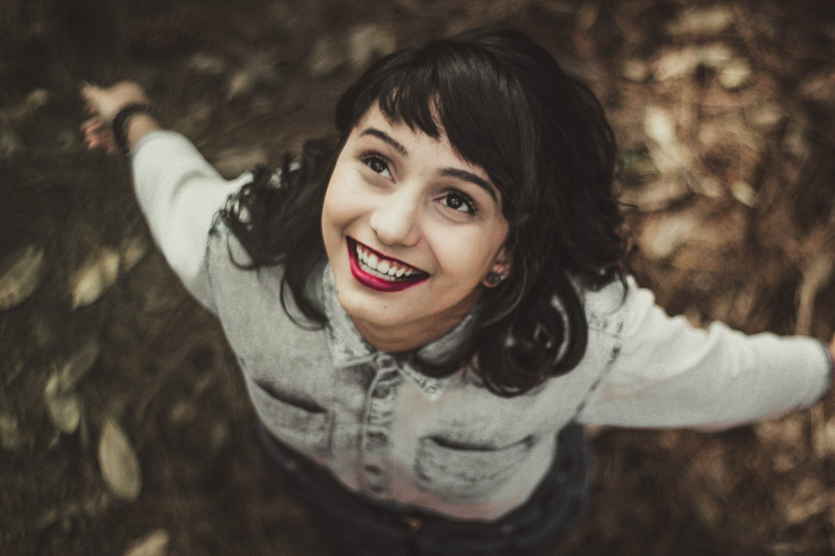 A Little Girl Standing In Funny Poses And Smiling Stock Photo