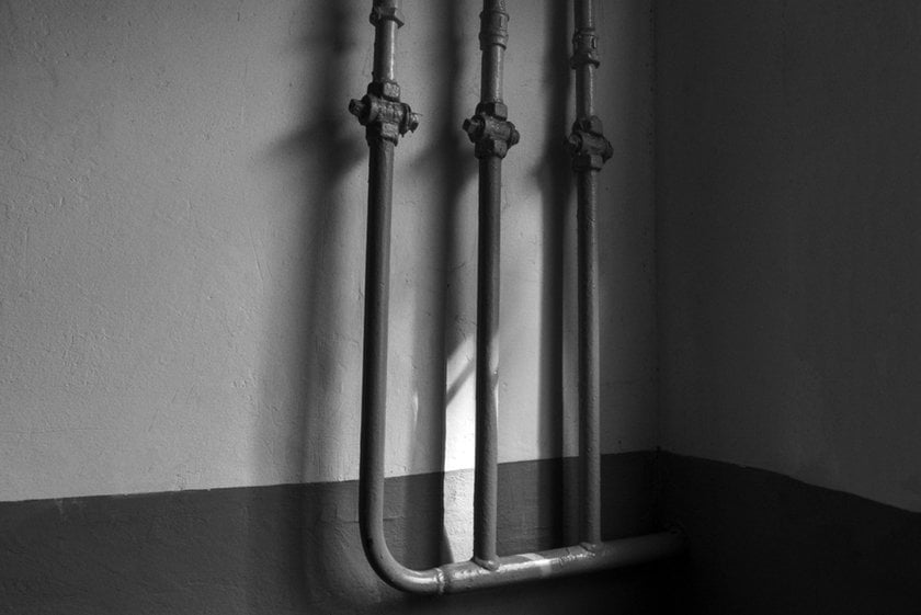 Black and white photo of pipes with rays of light | Skylum Blog