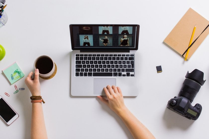 A photographer looks at photos on a laptop | Skylum Blog