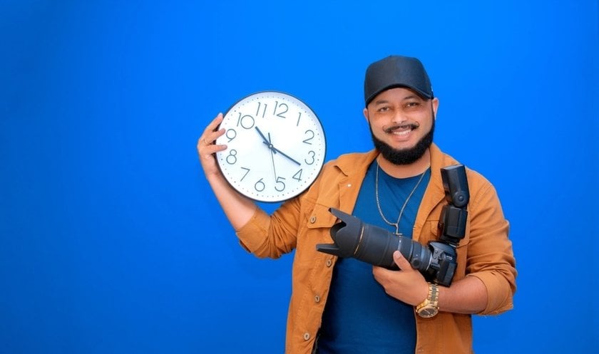 Photographer with a camera and a watch in his hands | Skylum Blog