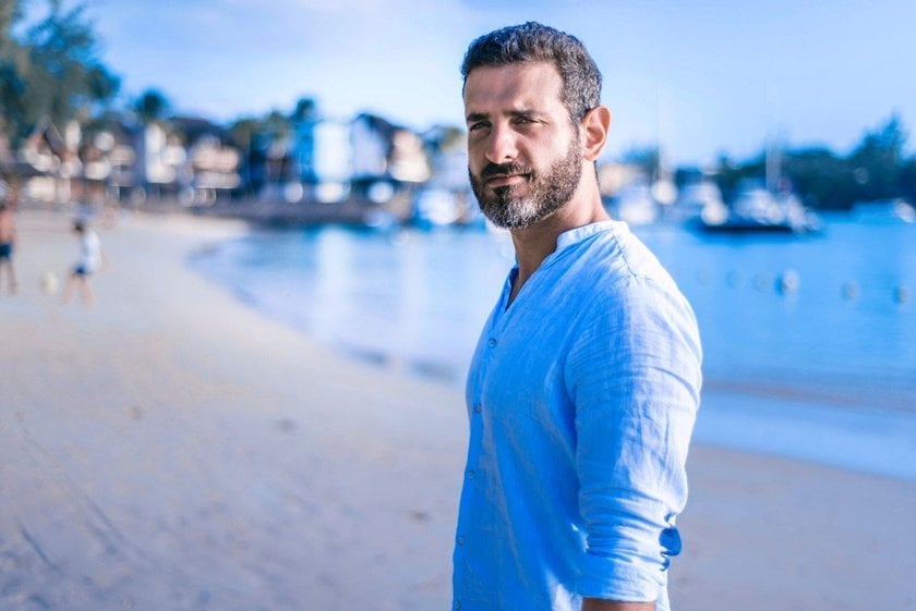 Serious Man in a Blue Shirt on the Beach | Skylum Blog