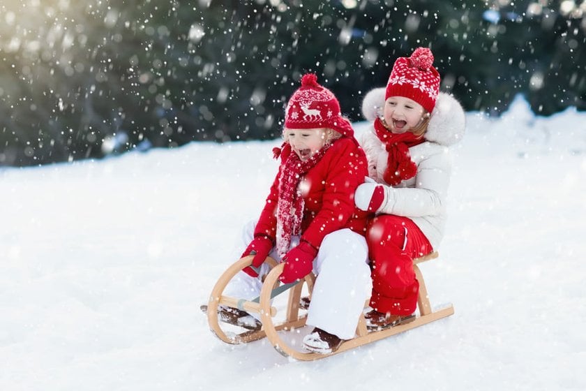 Children in Winter Outfits Sledding | Skylum Blog