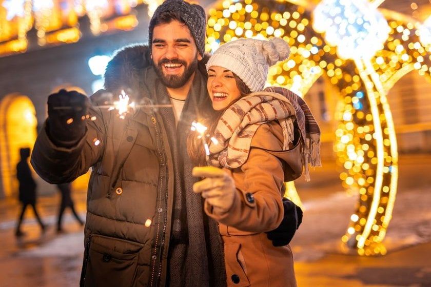 Happy Couple at a Winter Festival with Lights | Skylum Blog