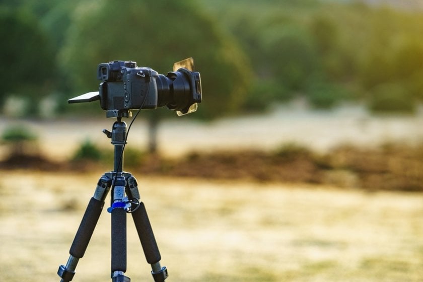 A camera on a tripod outdoors | Skylum Blog