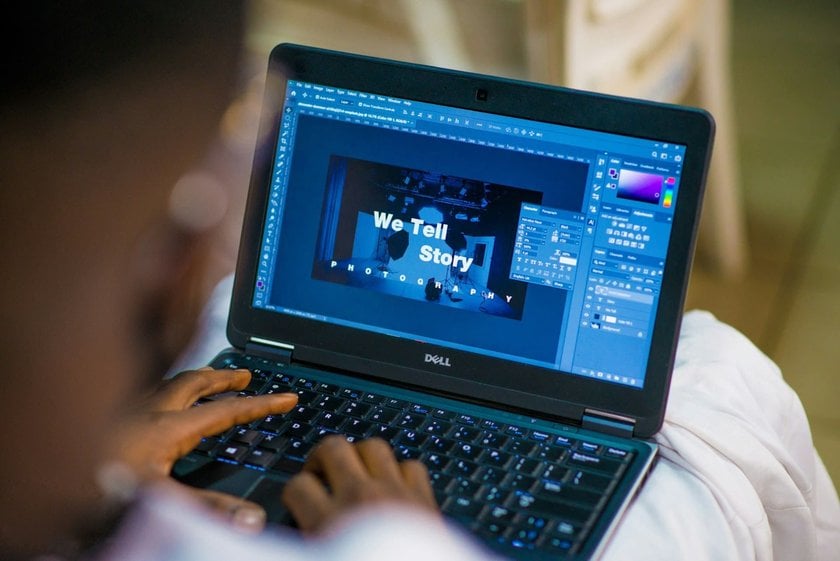 Man Editing a Photo on a Laptop in Photoshop | Skylum Blog