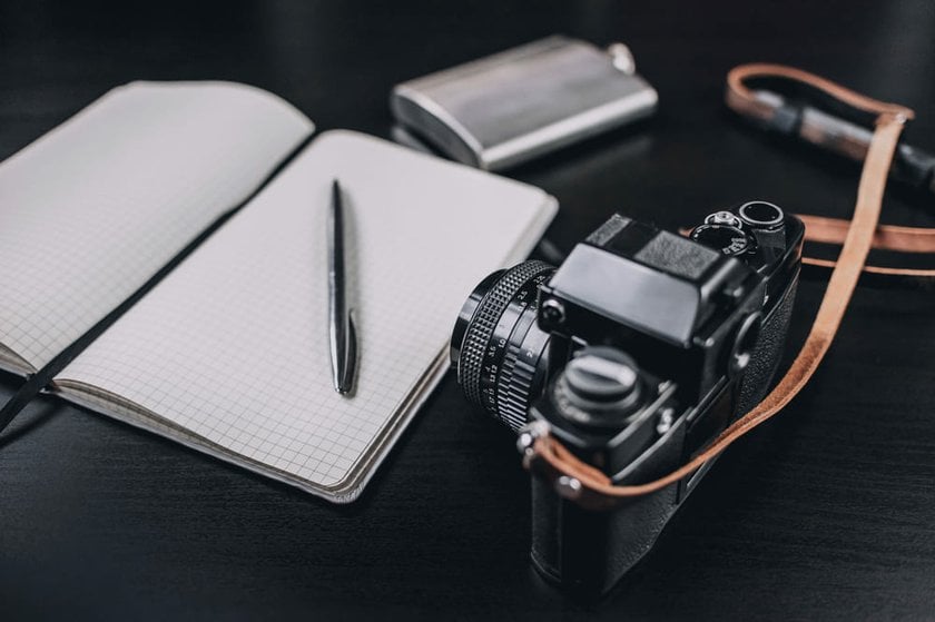 Retro Camera Positioned Next to an Open Notebook | Skylum Blog