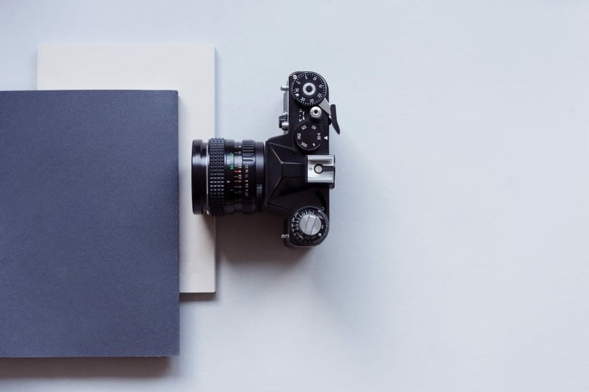 Camera Placed Beside Notebooks | Skylum Blog