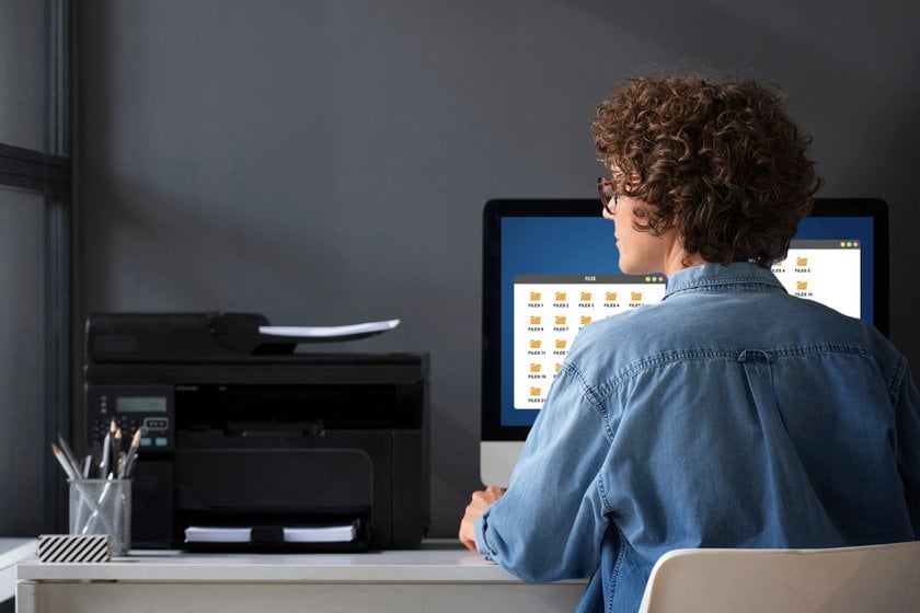 A girl is typing on a printer | Skylum Blog